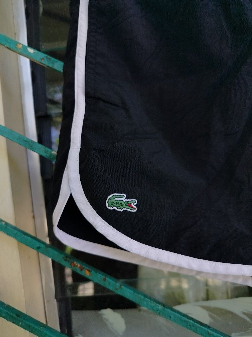 Lacoste Live Black Shorts Size 3 (Category: Shorts) located in Manila. Submitted by virgiliosa38485 (Listing ID 1465705087, Image 2). Description: - Brand: Lacoste Live - Color: Black with white trim - Size: Tagged Size 3 -Waist 28-34 - Waistband: Elastic with adjustable white drawstring and branded aglets - Logo: Small embroidered crocodile on the bottom left hem - Pocket: Single back pocket with white trim and button closure - Material: Lightwe