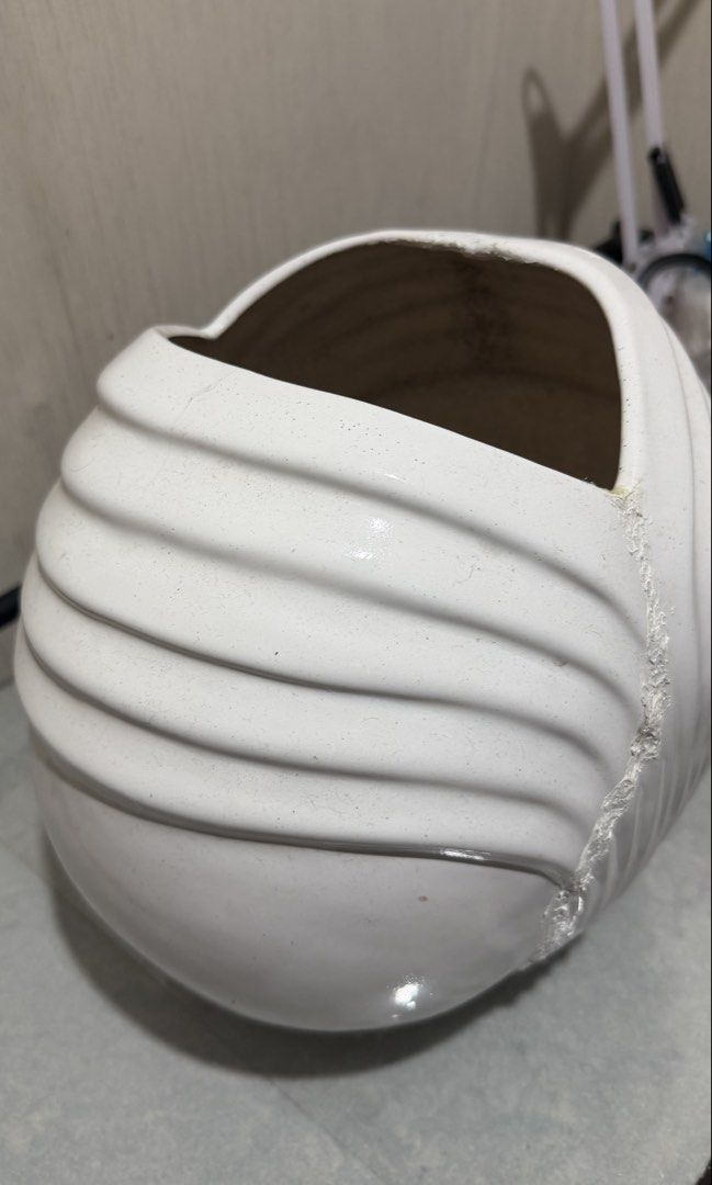 Large White Porcelain Shell-Style Decorative Vase (Category: Vases & Decorative Bowls) located in Valenzuela. Submitted by reighanthony (Listing ID 1465691989, Image 2). Description: Pre-loved piece with repaired hairline/crack. Crack was secured with adhesive and touched up with white acrylic paint as a personal restoration. Still sturdy and visually attractive; best used as a decorative/display piece..