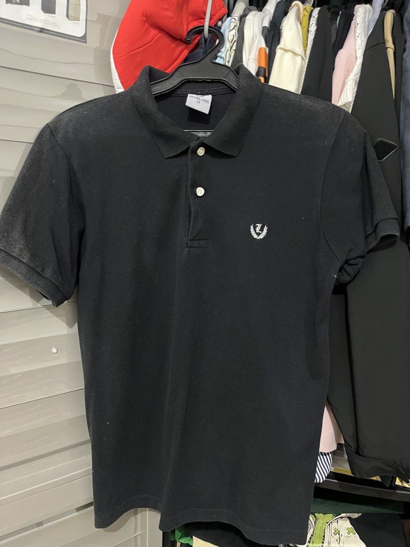 Level One Black Polo Shirt Size M (Category: Tshirts & Polo Shirts ) located in Imus. Submitted by nomsthriftshop (Listing ID 1465618027, Image 1). Description: - Brand/Model: Level One black polo shirt - Size: Medium (tag on collar) - Design: Classic button placket with white buttons and small embroidered wreath logo on left chest - Details: Ribbed collar and sleeve cuffs - Fit: Standard fit - Versatility: Perfect for casual days or smart casual