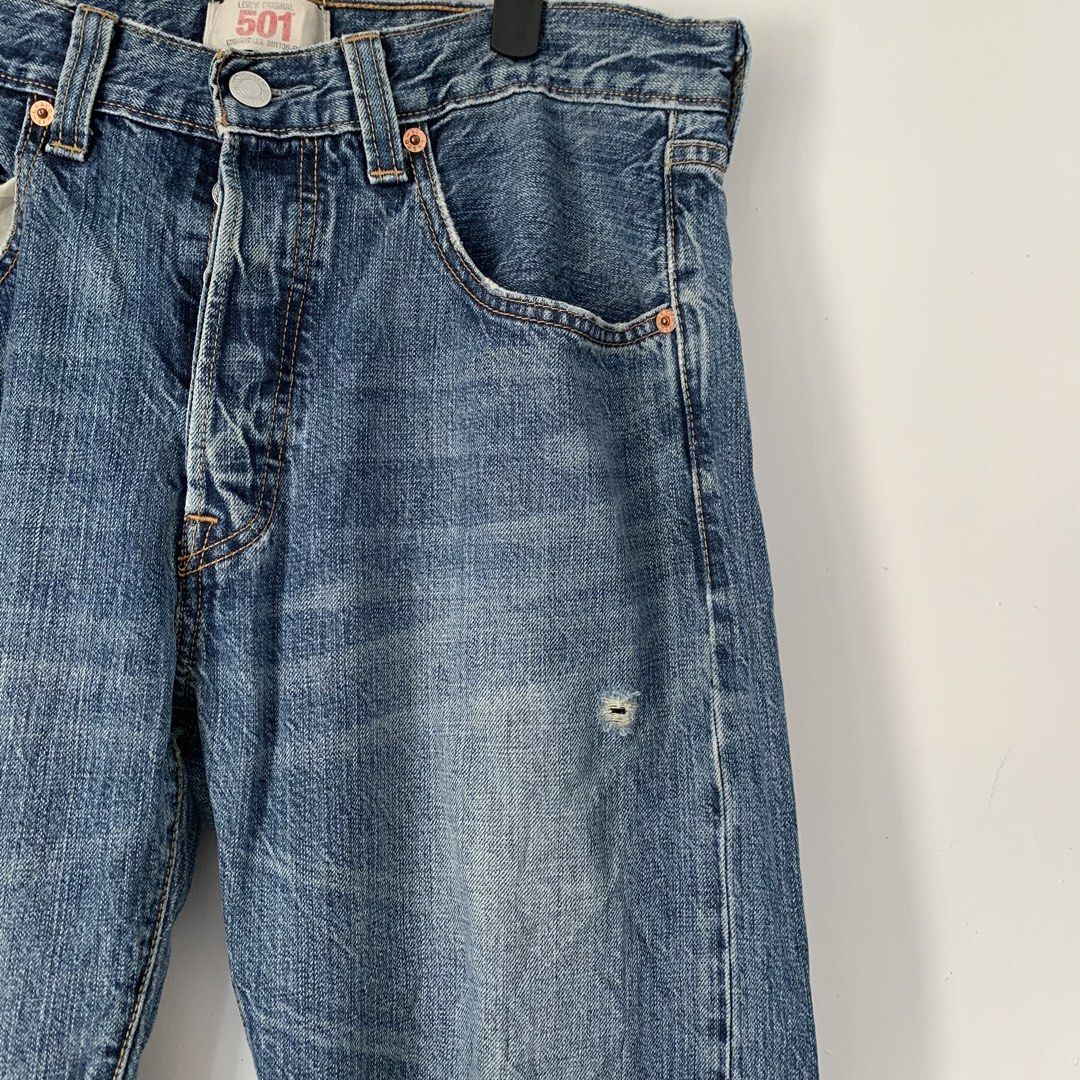 Levi's 501 Straight Leg Button Fly Jeans (Category: Jeans) located in Manila. Submitted by gentleflower-74686a (Listing ID 1465594166, Image 3). Description: - Brand/Model: Classic Levi's 501 Straight Leg Jeans - Waistline: 32 : Length: 38 - Wash: Medium blue denim with natural rope fading along the hem - Closure & Hardware: Signature button fly with durable copper-tone rivets - Details: Minor stylish distressing on the left leg - Authenticity: O