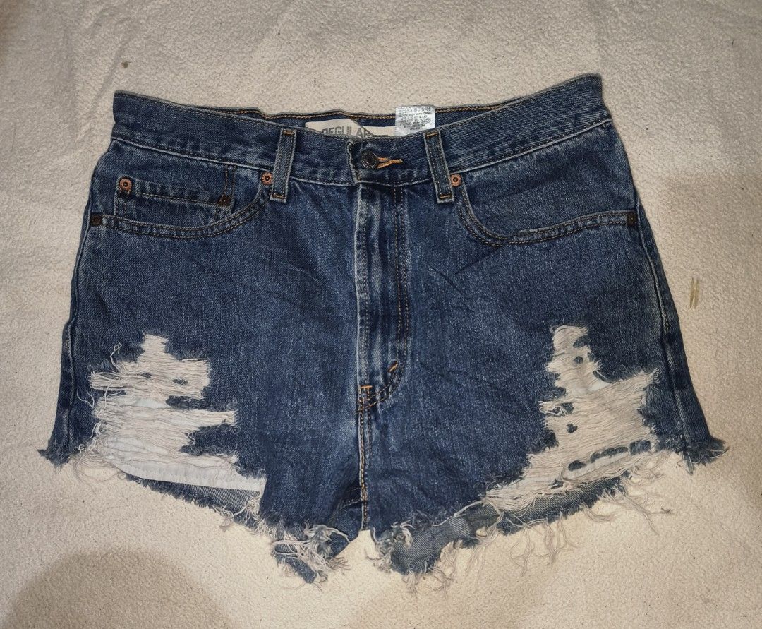 Levi's 505 Distressed Denim Shorts (Category: Shorts) located in Cagayan de Oro. Submitted by elijah350below (Listing ID 1465681953, Image 1). Description: - Brand: Levi's 505 - Style: Cut-off denim shorts in a dark wash - Fit: Mid to high rise with button fly - Size: W32 L29 (marked on classic leather back patch) - Details: Heavy front shredding, raw frayed hems, and back pocket red tab - Condition/Vibe: Classic vintage look, ideal for casual wa