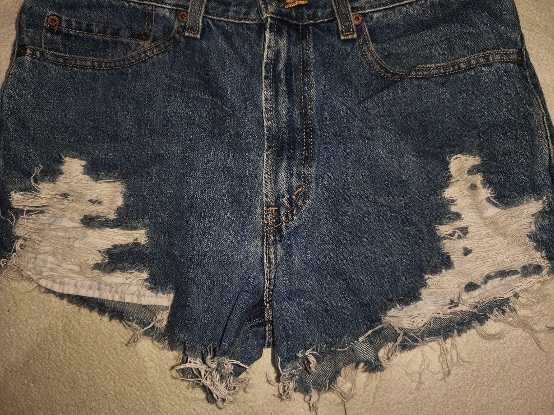 Levi's 505 Distressed Denim Shorts (Category: Shorts) located in Cagayan de Oro. Submitted by elijah350below (Listing ID 1465681953, Image 2). Description: - Brand: Levi's 505 - Style: Cut-off denim shorts in a dark wash - Fit: Mid to high rise with button fly - Size: W32 L29 (marked on classic leather back patch) - Details: Heavy front shredding, raw frayed hems, and back pocket red tab - Condition/Vibe: Classic vintage look, ideal for casual wa