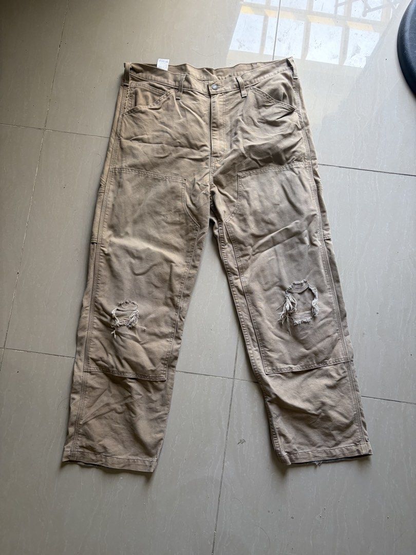Levi's Canvas Utility Work Pants Beige Distressed Knees (Category: Jeans) located in Taytay. Submitted by newphoenix.31abd6 (Listing ID 1465588407, Image 1). Description: - Brand: Levi's - Color: Tan - Style: Utility work pants / carpenter style with relaxed straight leg - Details: Double knees with distressing, side utility pockets, and iconic red tab - Special Feature: Inner pocket lining features Levi's 150 years text print - Material: Durable