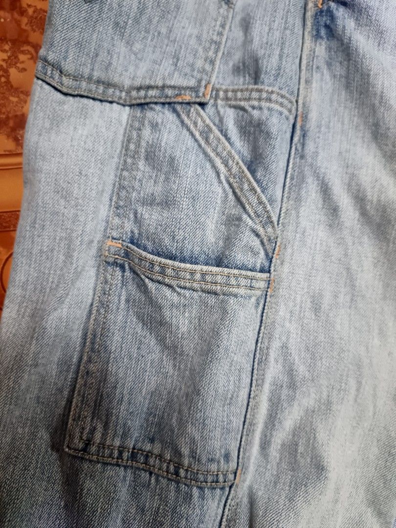 Levi's Carpenter Loose Straight Denim Jorts (Category: Shorts) located in Manila. Submitted by kiraaaaaaaaaaa (Listing ID 1465660218, Image 3). Description: - Brand: Levi's - Style: Carpenter denim shorts with loose straight fit - Wash: Light wash with factory distressing and frayed front rips - Details: Classic utility pockets and hammer loop - Closure: Button fly - Size: Tag W34 L30 (fits true to W34 waist) - Material: 100% cotton - Origin: Mad