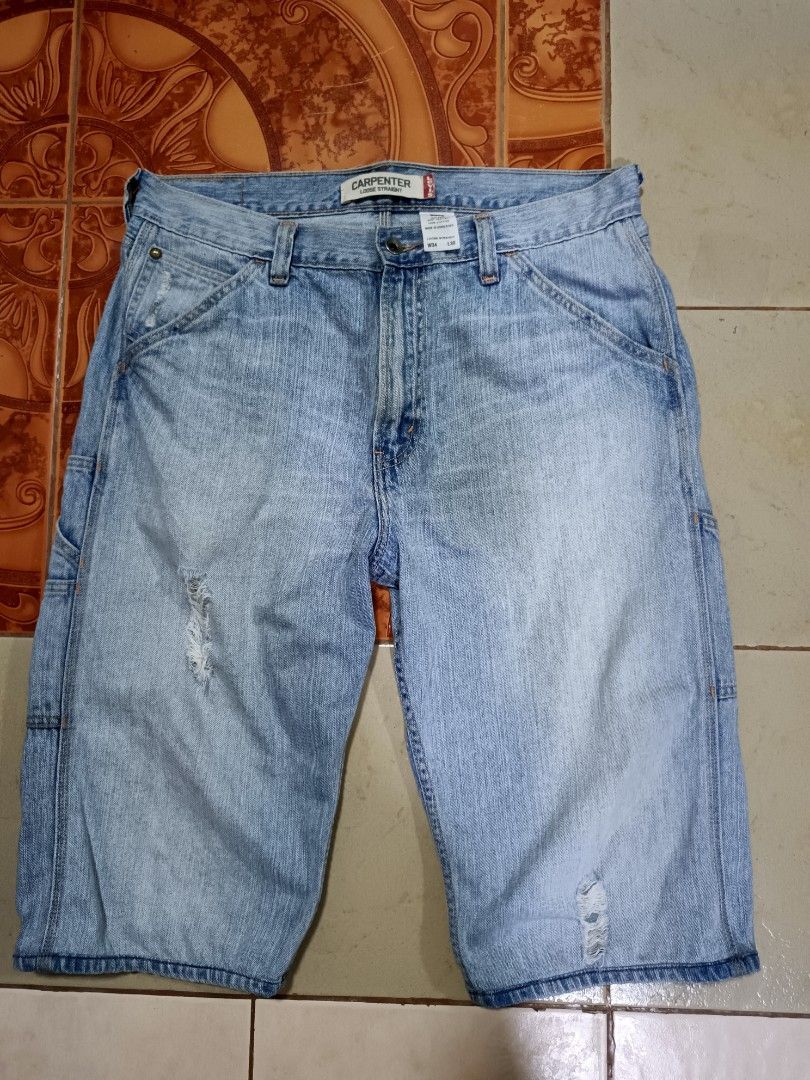 Levi's Carpenter Loose Straight Denim Jorts (Category: Shorts) located in Manila. Submitted by kiraaaaaaaaaaa (Listing ID 1465660218, Image 1). Description: - Brand: Levi's - Style: Carpenter denim shorts with loose straight fit - Wash: Light wash with factory distressing and frayed front rips - Details: Classic utility pockets and hammer loop - Closure: Button fly - Size: Tag W34 L30 (fits true to W34 waist) - Material: 100% cotton - Origin: Mad