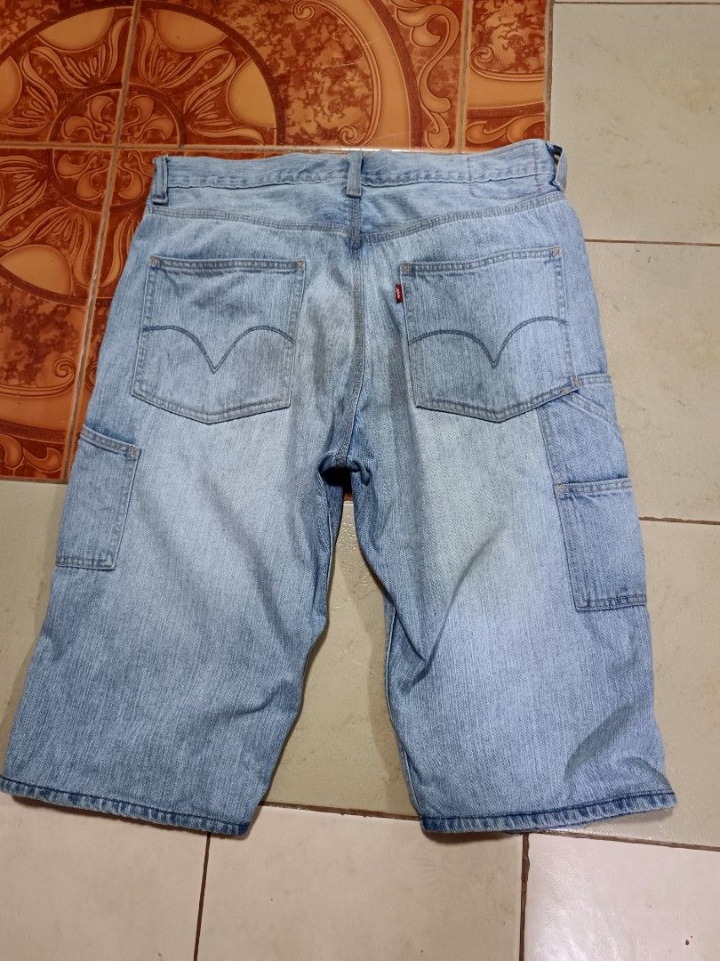 Levi's Carpenter Loose Straight Denim Jorts (Category: Shorts) located in Manila. Submitted by kiraaaaaaaaaaa (Listing ID 1465660218, Image 2). Description: - Brand: Levi's - Style: Carpenter denim shorts with loose straight fit - Wash: Light wash with factory distressing and frayed front rips - Details: Classic utility pockets and hammer loop - Closure: Button fly - Size: Tag W34 L30 (fits true to W34 waist) - Material: 100% cotton - Origin: Mad