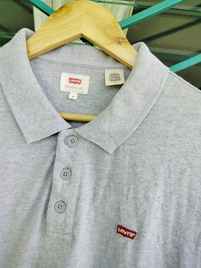 Levi's Grey Polo Shirt Size M (Category: Tshirts & Polo Shirts ) located in Manila. Submitted by virgiliosa38485 (Listing ID 1465705850, Image 2). Description: - Brand: Levi's - Color: Grey - Size: M (Standard fit) -Dimes 27×20 - Style: Short sleeve polo with button placket - Details: Iconic red Levi's logo tab on the chest - Condition: Clean, with original fabric and care labels intact - Perfect versatile basic for casual daily wear.