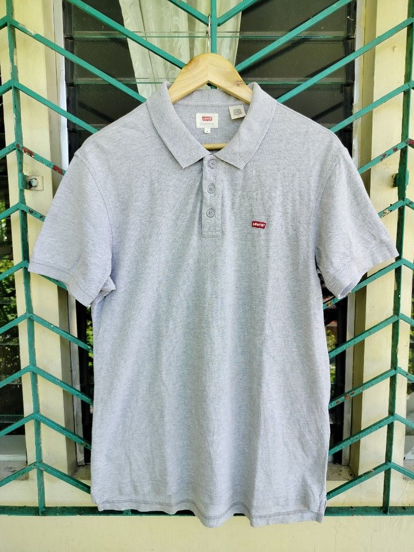 Levi's Grey Polo Shirt Size M (Category: Tshirts & Polo Shirts ) located in Manila. Submitted by virgiliosa38485 (Listing ID 1465705850, Image 1). Description: - Brand: Levi's - Color: Grey - Size: M (Standard fit) -Dimes 27×20 - Style: Short sleeve polo with button placket - Details: Iconic red Levi's logo tab on the chest - Condition: Clean, with original fabric and care labels intact - Perfect versatile basic for casual daily wear.