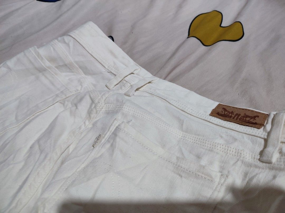 Levi's White Denim Shorts W28 (Category: Shorts) located in Manila. Submitted by mommyregsthriftclothes (Listing ID 1465633929, Image 3). Description: - Brand: Levi's - Color: Solid off-white - Size: W30 - Fit: Straight fit through the thigh - Closure: Button fly - Details: Classic back pockets with signature leather patch - Condition: Great versatile piece for warm weather.