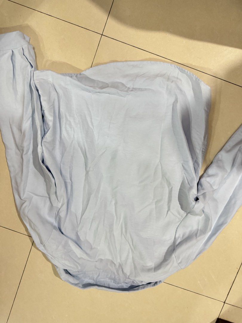 Light Blue Button-Down Long Sleeve Shirt (Category: Longsleeves) located in Quezon City. Submitted by sweetlyluxe (Listing ID 1465603794, Image 3). Description: - Color: Light blue - Style: Long sleeves, classic collar, front button closure - Fit: Standard fit with soft, comfortable fabric - Versatility: Great for layering or pairing with jeans and slacks, for work, corporate, office - Note: Needs a quick steam or iron before wearing.