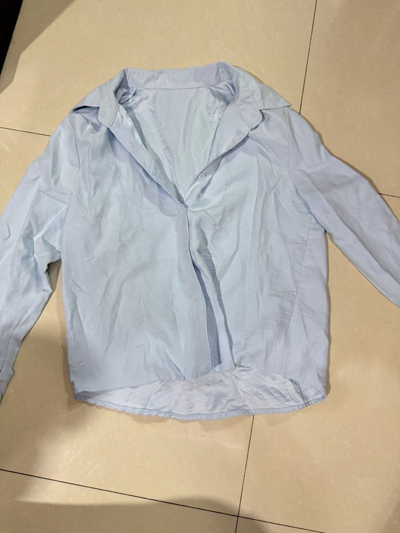 Light Blue Button-Down Long Sleeve Shirt (Category: Longsleeves) located in Quezon City. Submitted by sweetlyluxe (Listing ID 1465603794, Image 1). Description: - Color: Light blue - Style: Long sleeves, classic collar, front button closure - Fit: Standard fit with soft, comfortable fabric - Versatility: Great for layering or pairing with jeans and slacks, for work, corporate, office - Note: Needs a quick steam or iron before wearing.