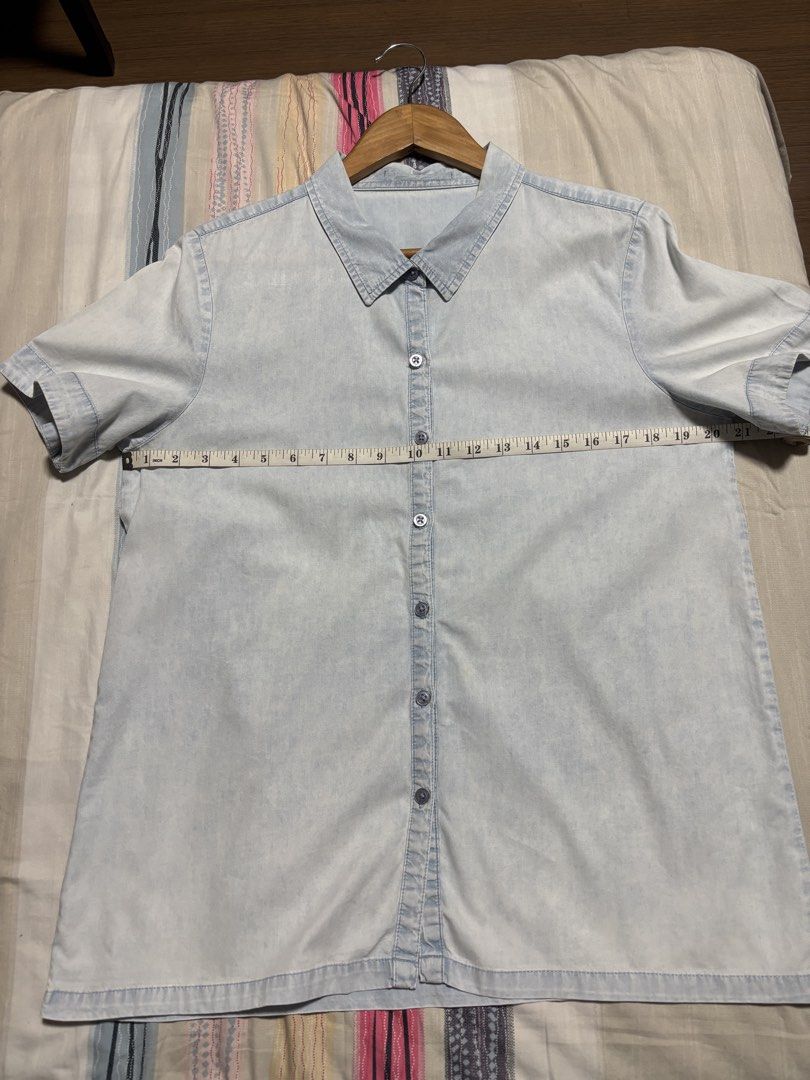 Light blue denim short sleeve button up shirt (Category: Shirts) located in Quezon City. Submitted by declutter_incorporated (Listing ID 1465693570, Image 2). Description: - Style: Casual short sleeve denim shirt - Color/Wash: Light wash - Details: Classic button-down front with standard collar - Condition: Clean, no major flaws noticed - Pairing: Easy to match with shorts or jeans.