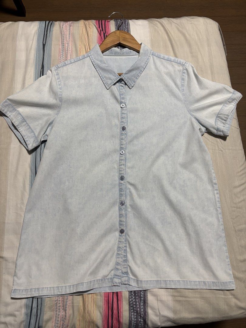 Light blue denim short sleeve button up shirt (Category: Shirts) located in Quezon City. Submitted by declutter_incorporated (Listing ID 1465693570, Image 1). Description: - Style: Casual short sleeve denim shirt - Color/Wash: Light wash - Details: Classic button-down front with standard collar - Condition: Clean, no major flaws noticed - Pairing: Easy to match with shorts or jeans.
