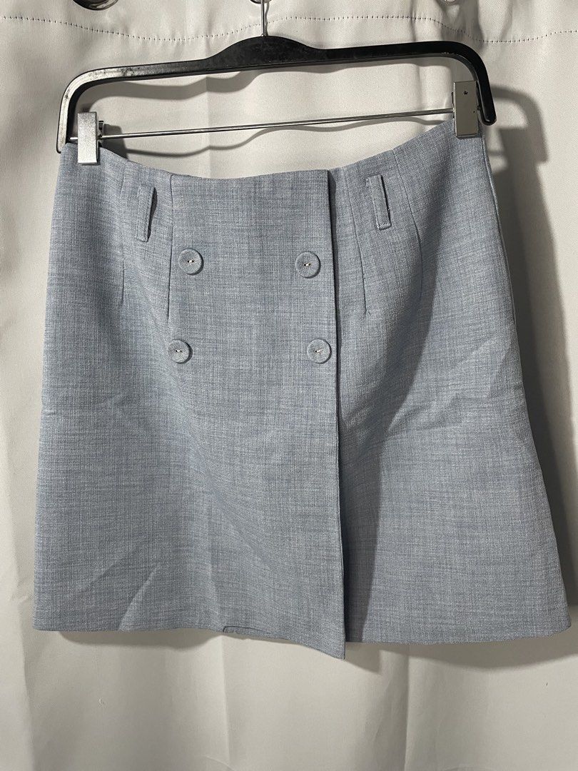 Light Blue Double-Breasted Mini Skirt (Category: Skirts) located in Bacoor. Submitted by prelovedbyphaty (Listing ID 1465583056, Image 1). Description: - Color: Light blue - Fabric: Textured material - Closure: Double-breasted front with 4 matching buttons - Fit: Structured waist with belt loops and darting for shape, straight cut - Length: Short - Versatility: Easy to dress up for work or casual weekends.