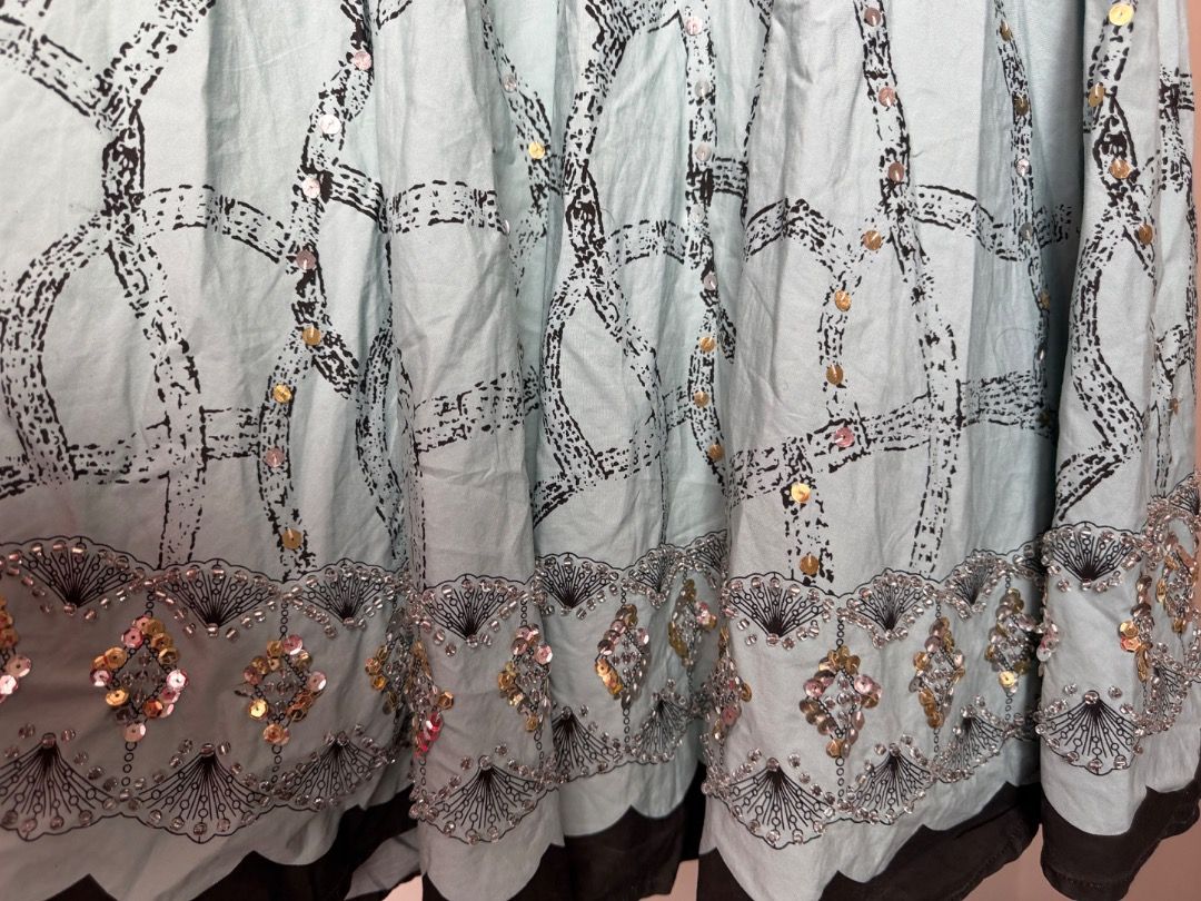 Light Blue Long Skirt with Sequins and Pattern (Category: Skirts) located in Naic. Submitted by _ookaymnl (Listing ID 1465636314, Image 3). Description: - Style: Light blue midi skirt with dark chain link pattern - Details: Covered in shiny gold and silver sequins all over - Hem: Heavy beaded embroidery along the scalloped hemline - Features: Dark lining underneath and convenient side zipper closure -hazelhazelhazel on tag - Occasion: Eye-catchin