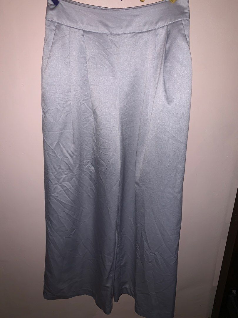 Light grey wide leg satin pants (Category: Jeans) located in Pasig City. Submitted by klaaaaa (Listing ID 1465583080, Image 1). Description: - Color: Light grey with a subtle sheen finish - Fit: High-waisted with a straight, wide-leg cut - Details: Elegant front pleats and functional side pockets - Waistband: Clean straight waistband (no belt loops) - Fabric: Smooth, lightweight, and comfortable for all-day wear - Hem: Clean, polished finish.