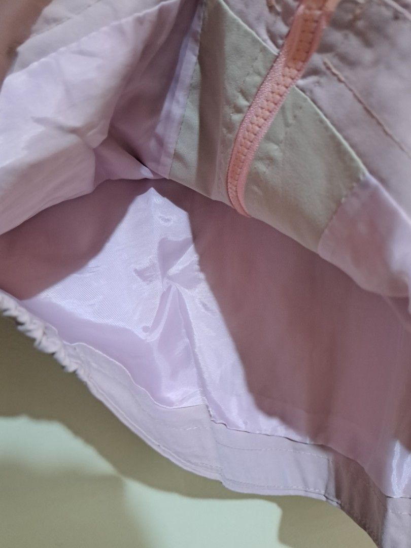 Light Pink Zip Up Hooded Windbreaker Jacket (Category: Coats, Jackets and Outerwear) located in Manila. Submitted by yselles__ (Listing ID 1465604315, Image 2). Description: - Color: Light pink - Style: Zip-up hoodie with smooth, lightweight inner lining - Features: Front pockets with button details, elastic cuffs and hem - Details: Cute print on the chest and unique back strap design - Condition: Clean, worn just a few times.
