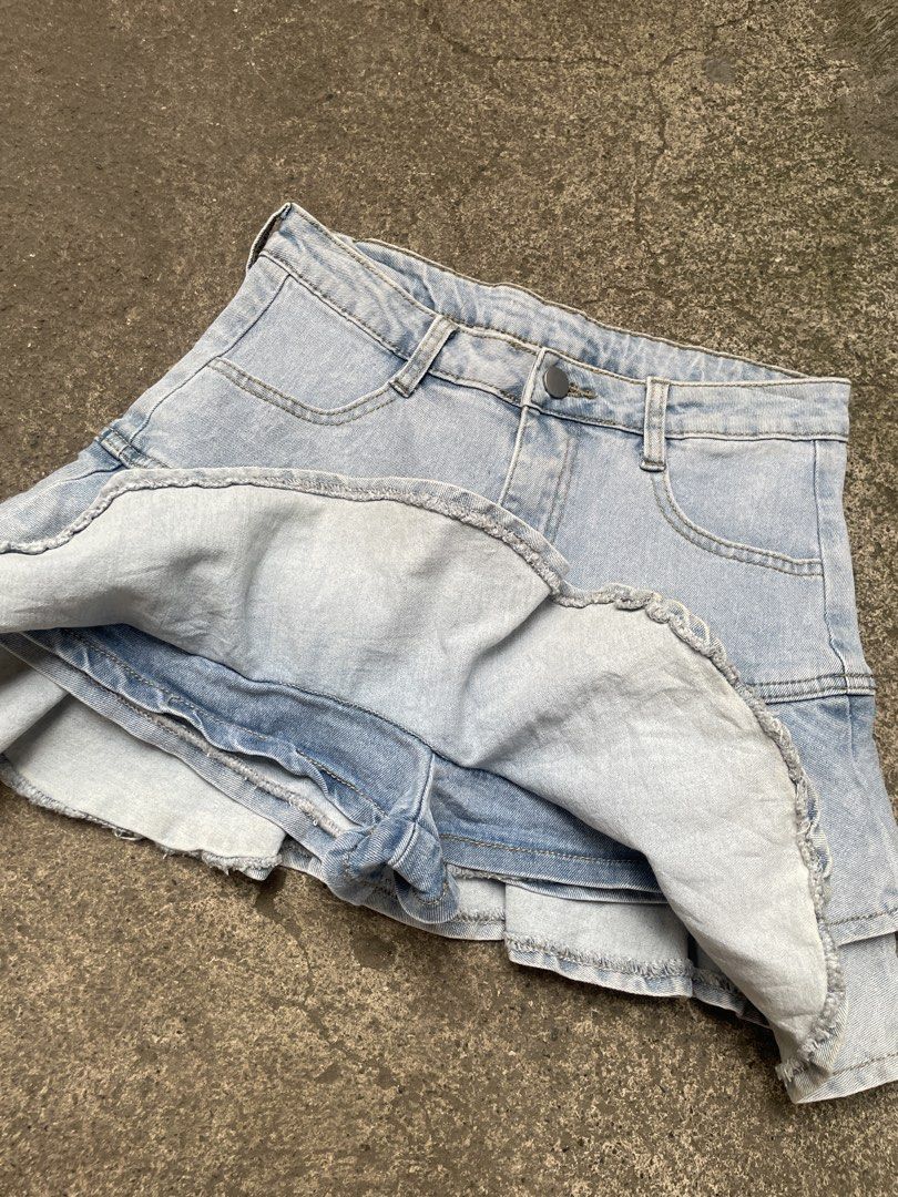 Light wash denim ruffle tiered skort shorts (Category: Skirts) located in Davao. Submitted by riab_qt (Listing ID 1465592525, Image 3). Description: - SIZE: 28” LENGTH: 14” - Style: Light blue denim skort with a Y2K casual vibe - Comfort: Built-in shorts underneath for worry-free wear - Design: Double-layered ruffle hem for a cute skirt look - Details: Front pockets, belt loops, and front button with zip fly closure - Versatility: Super easy to s