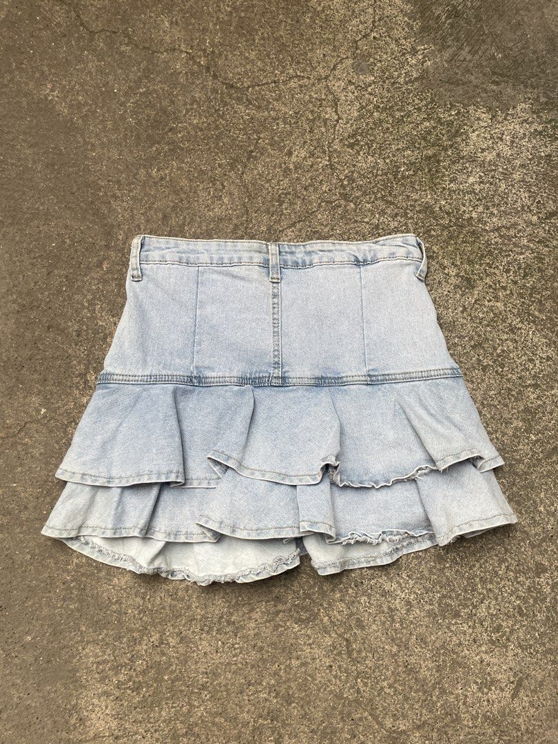 Light wash denim ruffle tiered skort shorts (Category: Skirts) located in Davao. Submitted by riab_qt (Listing ID 1465592525, Image 2). Description: - SIZE: 28” LENGTH: 14” - Style: Light blue denim skort with a Y2K casual vibe - Comfort: Built-in shorts underneath for worry-free wear - Design: Double-layered ruffle hem for a cute skirt look - Details: Front pockets, belt loops, and front button with zip fly closure - Versatility: Super easy to s