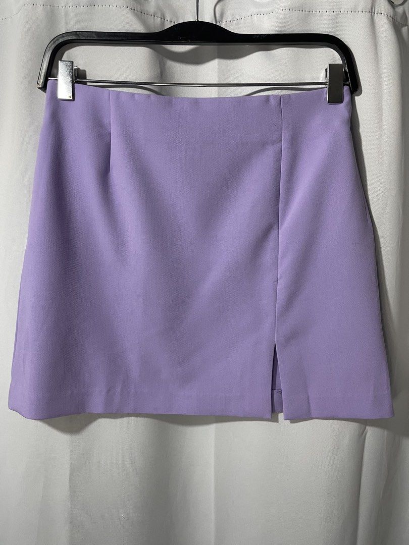 Lilac Mini Skirt with Front Slit (Category: Skirts) located in Bacoor. Submitted by prelovedbyphaty (Listing ID 1465582779, Image 1). Description: - Color: Lilac / Pastel - Style: Mini skirt with a clean, simple cut - Details: Structured waistband, front darts, and small slit near the right hem - Closure: Back zip - Perfect for: Spring and summer OOTDs.