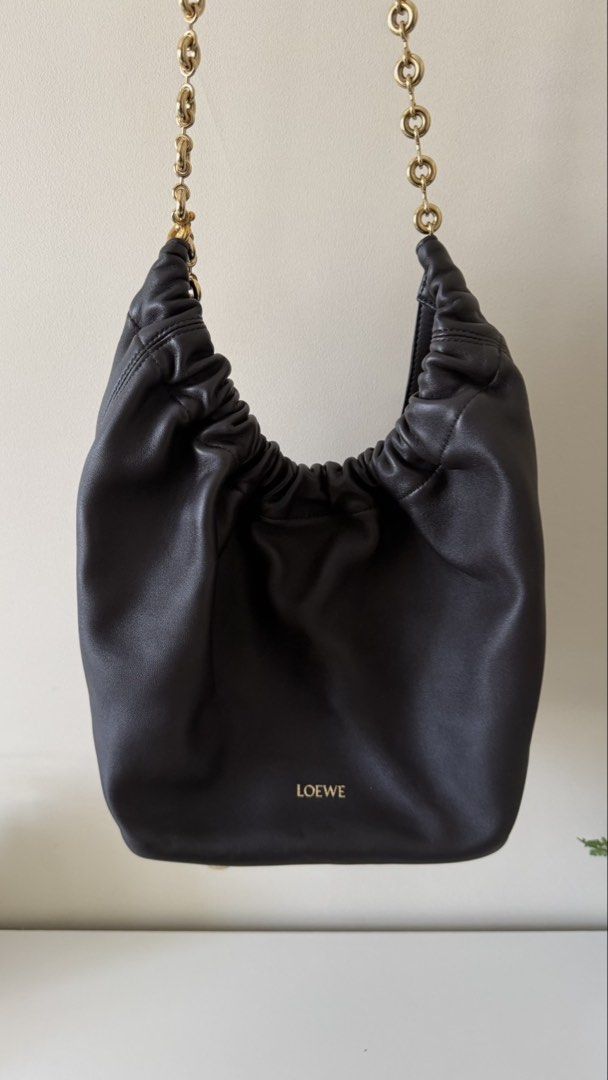 Loewe Squeeze Bag Black (Category: Luxury Bags & Wallets) located in Manila. Submitted by chuchay2020 (Listing ID 1465722984, Image 1). Description: - Brand: Loewe Squeeze Bag - Color/Material: Black supple nappa lambskin - Hardware: Gold-tone donut chain strap with engraved Anagram detail - Design: Soft pleated silhouette with gathered top handle - Condition: Pristine, absolutely gorgeous - Inclusions: Original box, paper bag, and embroidered lo