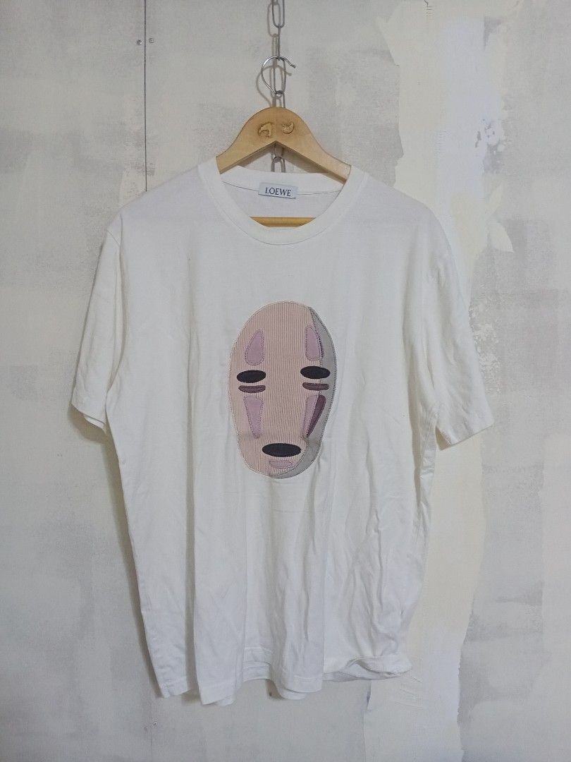 LOEWE White Graphic Embroidered T-Shirt (Category: Shirts) located in San Jose del Monte. Submitted by dripfromthrift2 (Listing ID 1465579396, Image 1). Description: - Brand: Loewe - Color: White with pale pink, grey, and black abstract face embroidery - Fit: Classic relaxed fit with a clean crew neckline - Material: Soft, premium cotton - Condition: Excellent / Like new - Style: Versatile everyday basic with unique designer detailing.
