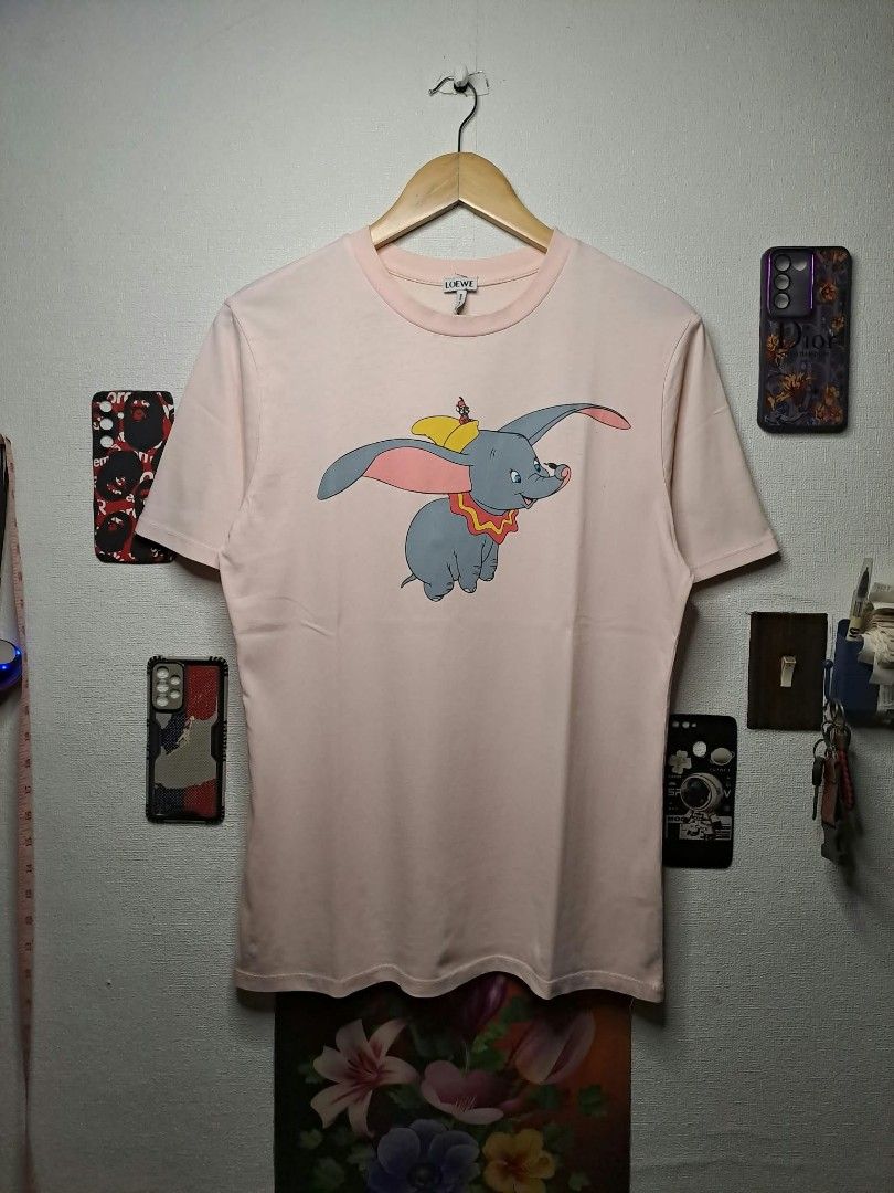 Loewe x Disney Dumbo (Category: Shirts) located in Quezon City. Submitted by yaseen73 (Listing ID 1465653969, Image 1). Description: Loewe x Disney Dumbo Wearing Size : Small - Medium Color Rate : 9.9/10 - Issue : Stain (See Photo) - Condition : 5/5 350 only Shipped Via J&T Express MOP : G C A S H B A N K T R A N S F E R Seller's Location : 📍Brgy. Pansol, Q.C.