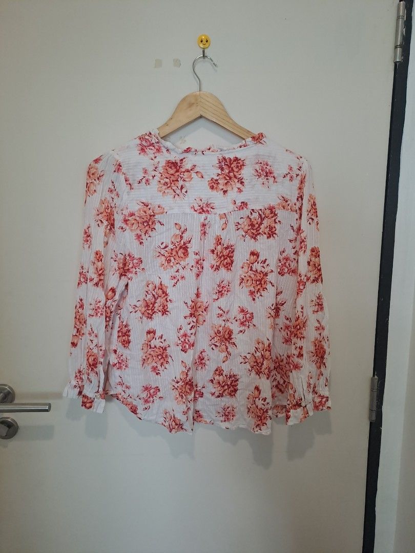 LOFT BY ANN TAYLOR FLORAL LONGSLEVE (Category: Longsleeves) located in Manila. Submitted by joanbalde39643 (Listing ID 1465671916, Image 3). Description: This item is a LOFT Bouquet Lacey Ruffle Cotton Blouse. It features a vibrant coral/pink floral pattern over a crisp white cotton fabric, detailed with delicate horizontal lace paneling across the chest, subtle vertical woven stripes, and an airy split neckline with a button-front closure..