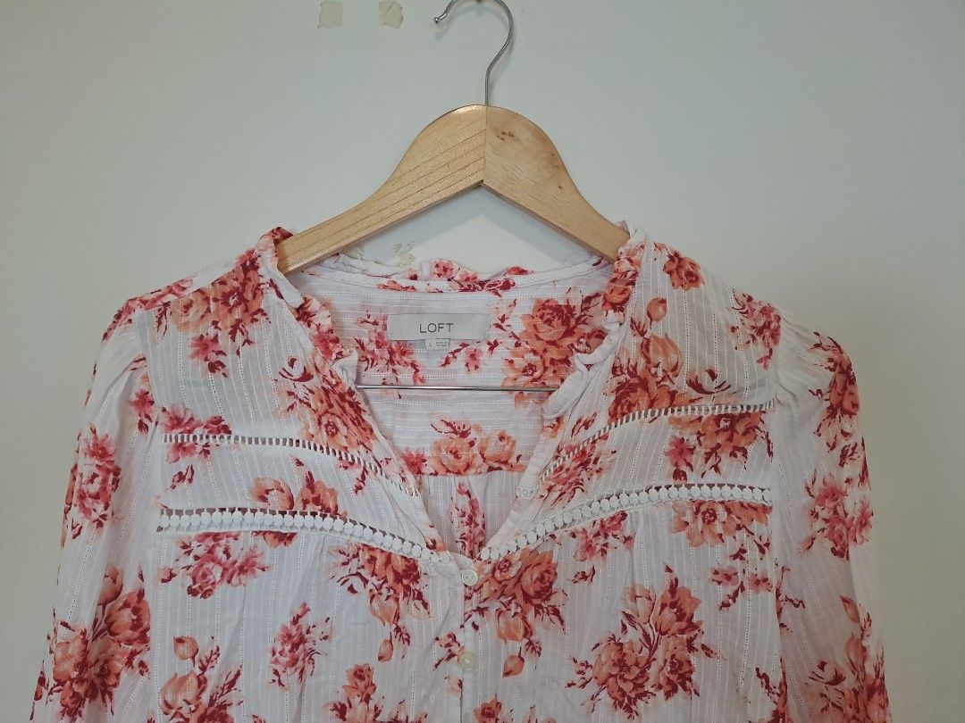 LOFT BY ANN TAYLOR FLORAL LONGSLEVE (Category: Longsleeves) located in Manila. Submitted by joanbalde39643 (Listing ID 1465671916, Image 2). Description: This item is a LOFT Bouquet Lacey Ruffle Cotton Blouse. It features a vibrant coral/pink floral pattern over a crisp white cotton fabric, detailed with delicate horizontal lace paneling across the chest, subtle vertical woven stripes, and an airy split neckline with a button-front closure..