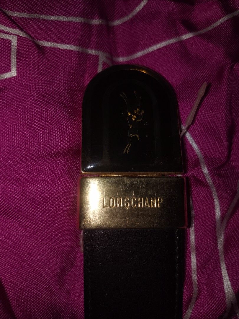 Longchamp Black Leather Belt with Gold Hardware (Category: Belts) located in San Juan City. Submitted by swiftfox.62e2f4 (Listing ID 1465692669, Image 3). Description: - Authentic Longchamp leather belt - Classic black strap with gold-tone metal buckle featuring signature horse logo - Stamped Longchamp Paris on the clasp - Standard width, perfect for daily wear or formal outfits - Clean stitching along the edges - Minor scuffs on metal hardware f