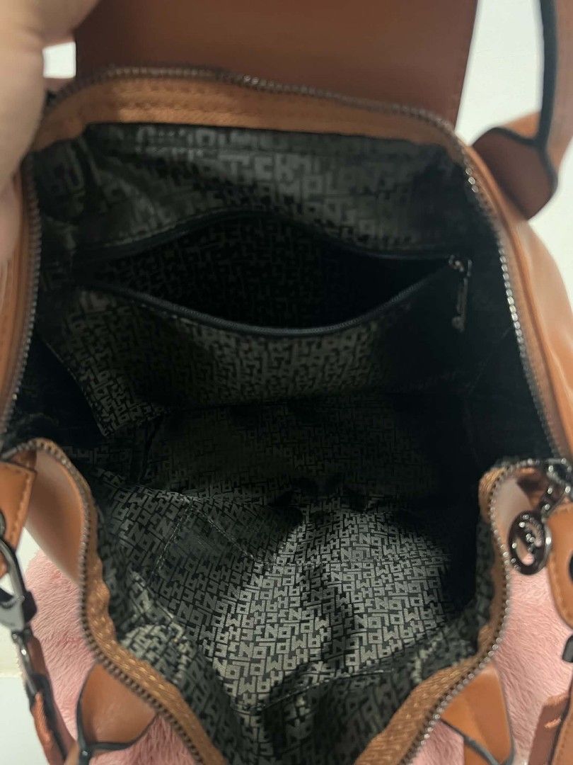 Longchamp Sig Strap Leather Bag (Category: Luxury Bags & Wallets) located in Paoay. Submitted by rvf1230 (Listing ID 1465662849, Image 3). Description: - Brand: Longchamp - Material: Rich cognac leather with dark gunmetal hardware - Closure: Secure zip-top with snap flap detail - Straps: Double top handles and a wide adjustable branded shoulder strap - Interior: Fully lined with signature Longchamp fabric and includes a zippered pocket - Conditio