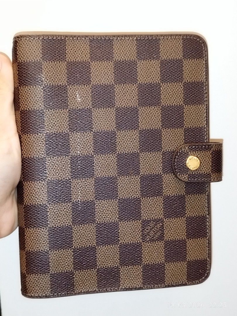 Louis Vuitton Damier Ebene Agenda Cover (Category: Luxury Bags & Wallets) located in Cebu City. Submitted by jplc24 (Listing ID 1465719772, Image 1). Description: - Louis Vuitton agenda cover in iconic Damier Ebene canvas - Model code R20240 - Secure snap button closure with polished gold-tone hardware - Standard planner ring binder mechanism inside - Features the classic Louis Vuitton Paris Made in France heat stamp - Excellent for daily plannin
