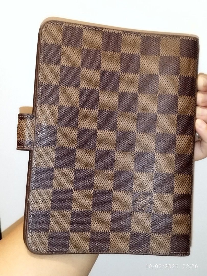 Louis Vuitton Damier Ebene Agenda Cover (Category: Luxury Bags & Wallets) located in Cebu City. Submitted by jplc24 (Listing ID 1465719772, Image 3). Description: - Louis Vuitton agenda cover in iconic Damier Ebene canvas - Model code R20240 - Secure snap button closure with polished gold-tone hardware - Standard planner ring binder mechanism inside - Features the classic Louis Vuitton Paris Made in France heat stamp - Excellent for daily plannin