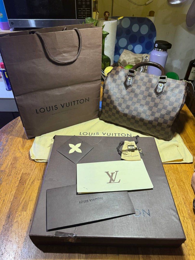Louis Vuitton Damier Ebene Speedy 30 Handbag (Category: Luxury Bags & Wallets) located in Manila. Submitted by graaaaannny (Listing ID 1465601416, Image 2). Description: - Brand: Louis Vuitton - Model: Damier Ebene Handbag Speedy 30 - Color/Pattern: Brown Checkered Canvas - Hardware: Gold-tone - Handles: Double top handles - Customization: Subtle L.S. initials stamped on the front leather tab - Condition: Clean interior and corners, excellent ove