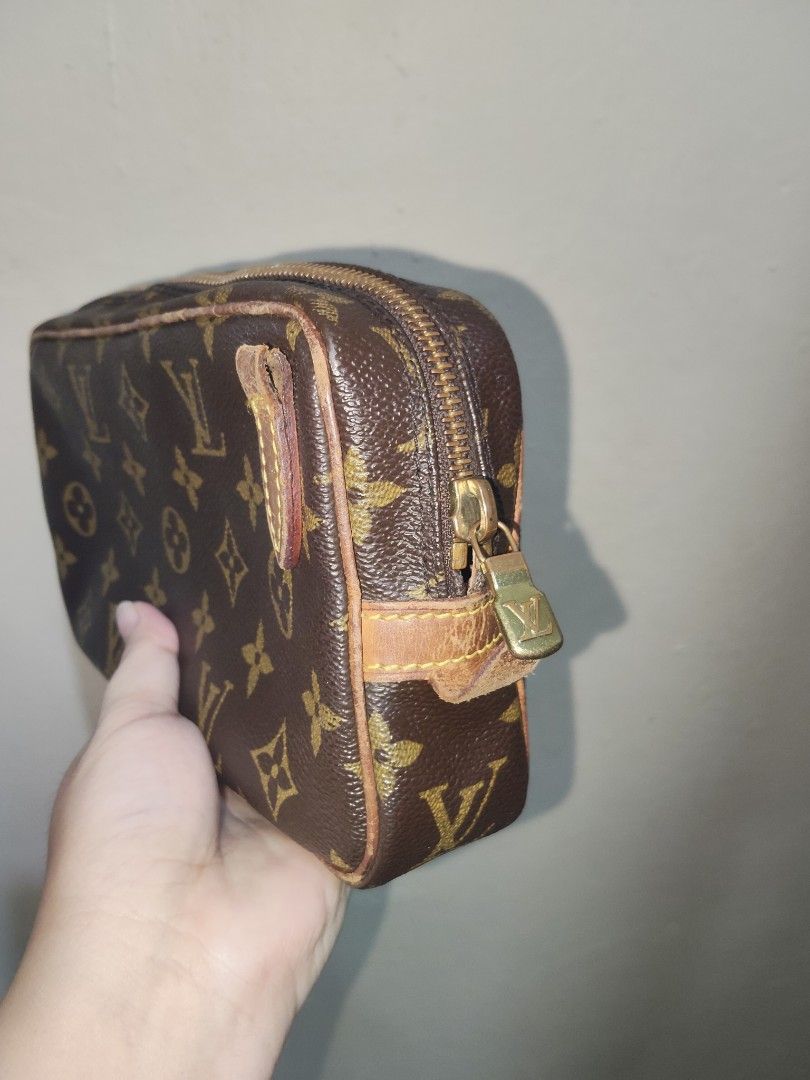Louis Vuitton Marly (Category: Luxury Bags & Wallets) located in Taguig. Submitted by luxurycollections.ph (Listing ID 1465721467, Image 3). Description: - Authentic Louis Vuitton bag in classic monogram canvas - Secure zip-around closure with gold-tone LV hardware - Durable brown leather piping along the edges - Compact rectangular shape ideal for travel or organizing essentials.
