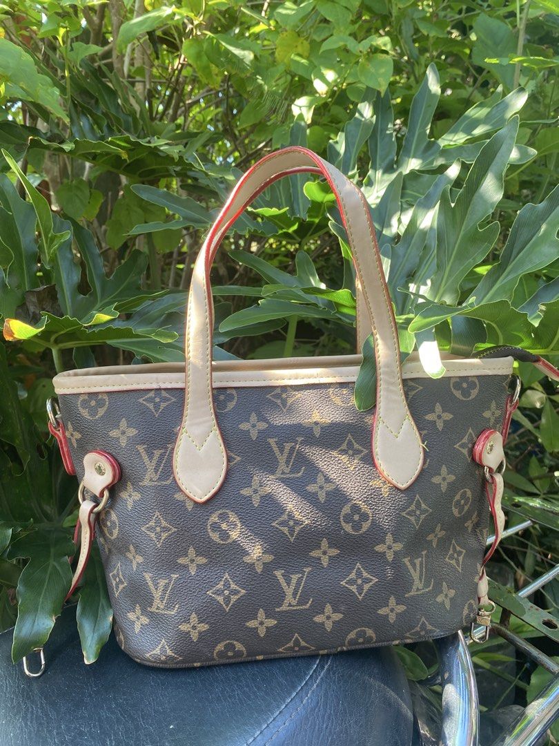 Louis Vuitton Monogram Canvas Tote Handbag (Category: Luxury Bags & Wallets) located in Manila. Submitted by cdb_22 (Listing ID 1465597080, Image 2). Description: - Authentic Louis Vuitton Monogram canvas handbag - Classic brown and tan pattern with signature LV logos - Dual top handles in light leather with stylish red edge glazing - Premium gold-tone hardware rings and side hooks - Secure zip top closure for your daily essentials - Compact and 