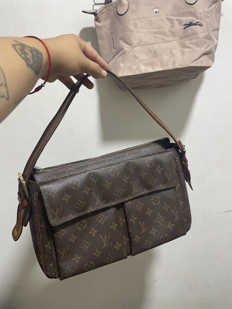 Louis Vuitton Monogram Canvas Shoulder Bag with Front Pockets (Category: Shoulder Bags) located in Santiago. Submitted by UkayLuxxSelector (Listing ID 1465652075, Image 1). Description: - Louis Vuitton Monogram canvas shoulder bag - Brown leather strap with stylish contrast yellow stitching - Secure top zip closure with handy front flap pockets - Vibrant red textile lining inside with convenient slip pockets - Classic brass-tone hardware througho