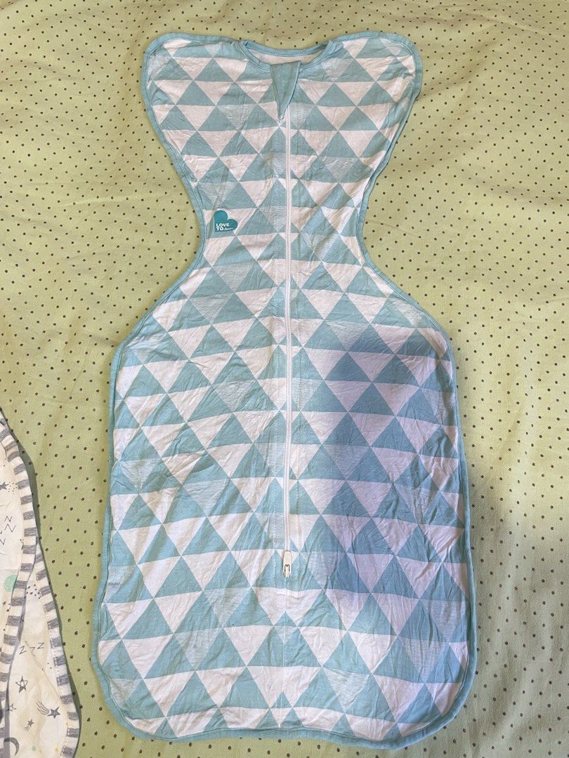 Love To Dream Swaddle UP Bundle (4 pieces) (Category: Breastfeeding & Bottle Feeding) located in San Jose del Monte. Submitted by momma_buys (Listing ID 1465599048, Image 2). Description: - Bundle of 4 Love To Dream swaddles - Designs: Grey, blue geometric triangles, white with grey stars, and white with yellow moons & stars - Features two-way zippers for hassle-free diaper changes - Soft, stretchy fabric that promotes the natural arms-up sleepin