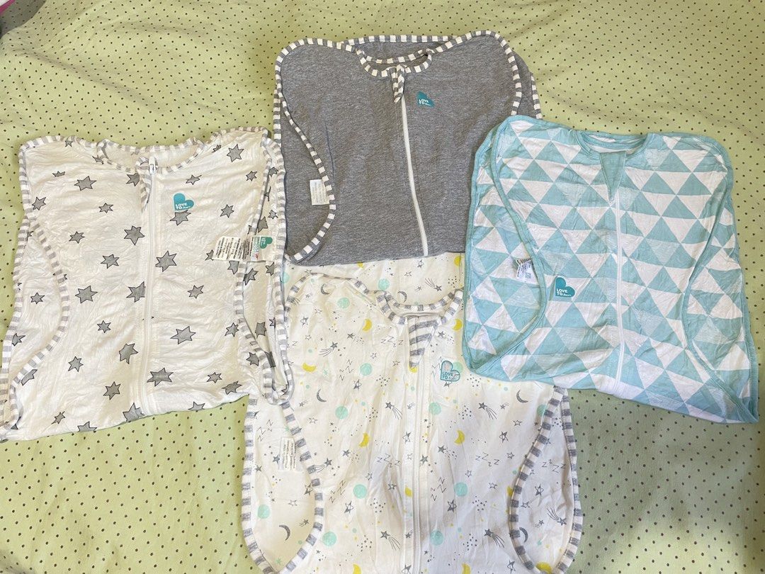 Love To Dream Swaddle UP Bundle (4 pieces) (Category: Breastfeeding & Bottle Feeding) located in San Jose del Monte. Submitted by momma_buys (Listing ID 1465599048, Image 1). Description: - Bundle of 4 Love To Dream swaddles - Designs: Grey, blue geometric triangles, white with grey stars, and white with yellow moons & stars - Features two-way zippers for hassle-free diaper changes - Soft, stretchy fabric that promotes the natural arms-up sleepin