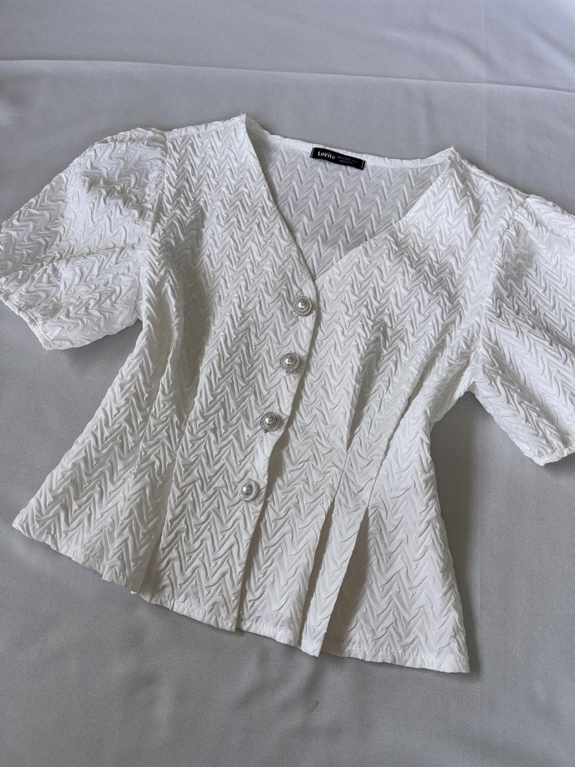 Lovito White Textured V-Neck Blouse Size XS (Category: Blouses) located in Tarlac. Submitted by haleyjames_scott (Listing ID 1465595006, Image 1). Description: • Size: XS on tag (mej maluwag sa akin so I think S safest size!) •Only used once •Buttons working.