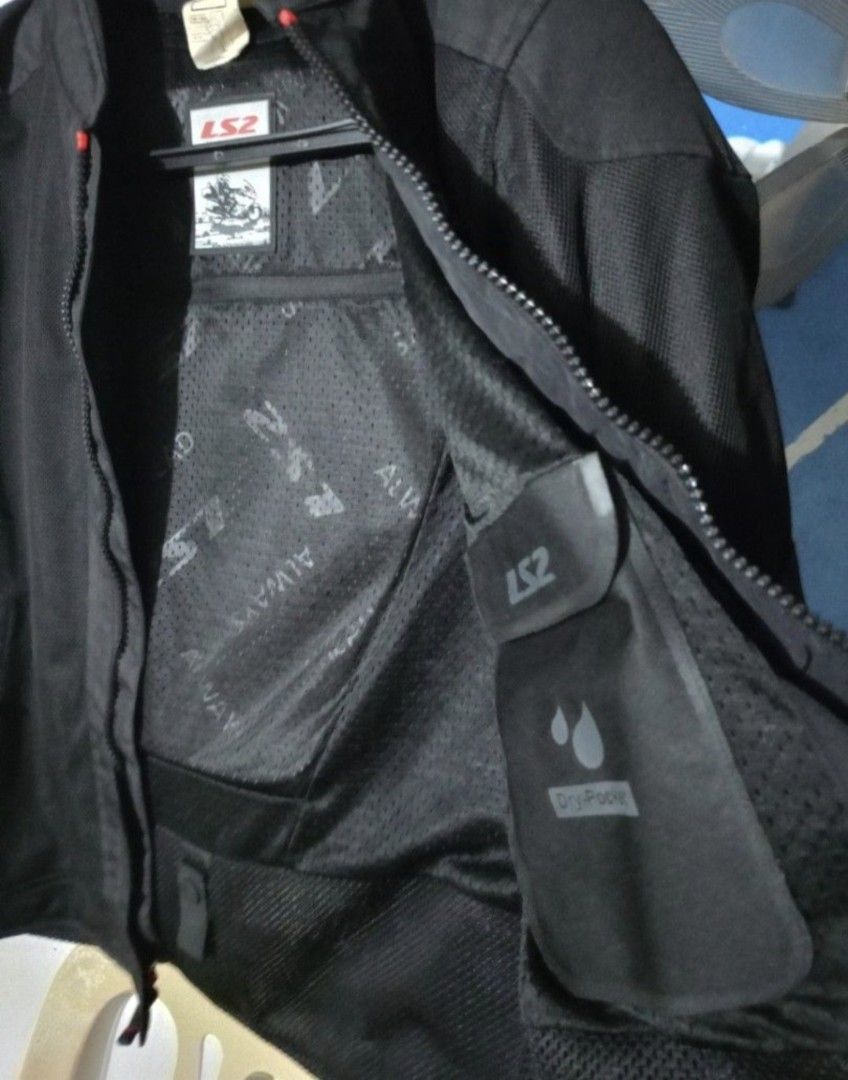 LS2 Black Mesh Riding Jacket (Category: Coats, Jackets and Outerwear) located in Imus. Submitted by emajay24 (Listing ID 1465596774, Image 3). Description: - Brand/Model: LS2 riding jacket - Color: Solid black with stylish red accents along the zipper and collar trim - Ventilation: Breathable mesh panels for maximum airflow on warm days - Storage: Full front zip closure, zippered chest pocket, and secure inner pockets - Design: Lightweight constr