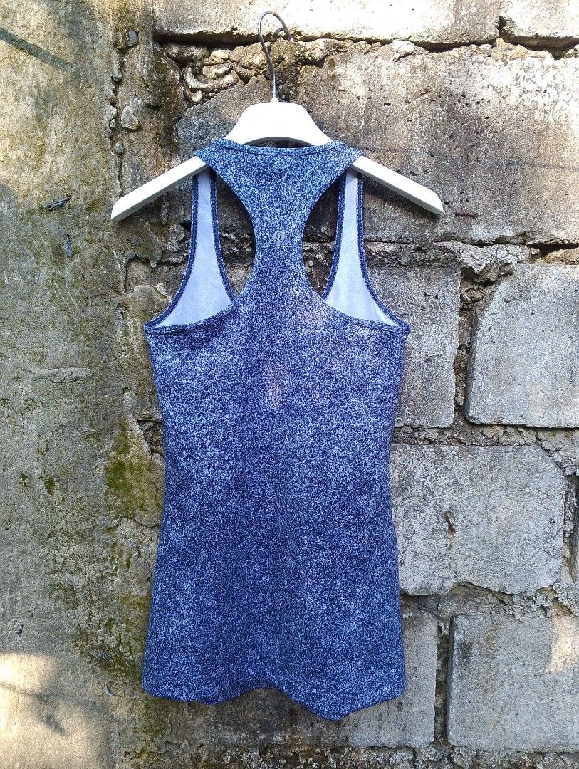 Lululemon Athletica Racerback Tank Top (Category: Activewear) located in Baliuag. Submitted by retrovault83 (Listing ID 1465675220, Image 2). Description: ✨ Condition: 9/10 – Excellent Preloved Condition 📏 Measurements (Flat Lay, Tagged Size 4): • Width: 24 - 26 • Length: 26 ✅ Details: • Authentic Lululemon Athletica racerback tank top • Heathered / speckled navy blue activewear fabric • Signature metallic silver Lululemon logo on upper back • S