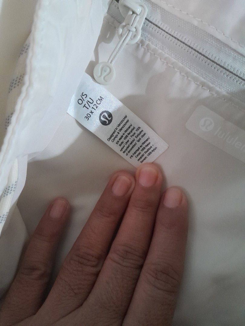 Lululemon Off-White Nylon Backpack O/S 30x12cm (Category: Backpacks) located in Rizal. Submitted by bravefish_da429e (Listing ID 1465665878, Image 2). Description: - Brand: Lululemon - Color: Off-white - Material: 100% recycled nylon (lightweight) - Dimensions: 30 x 12 cm (One Size) - Closure: Front flap with buckle and cinch drawstrings - Pockets: Front zippered pocket and inner zip pocket - Straps: Adjustable shoulder straps - Condition: Clean,