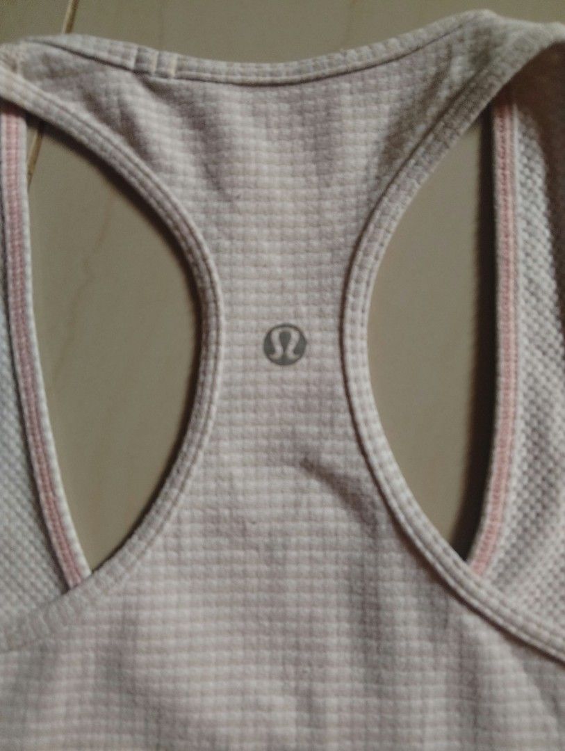Lululemon Racerback Tank Top Light Pink (Category: Sleeveless) located in Baybay. Submitted by thriftits00 (Listing ID 1465650760, Image 3). Description: - Brand: Lululemon - Style: Racerback tank top with classic scoop neckline - Color: Light pink - Material: Breathable, textured waffle knit fabric - Details: Signature silver Lululemon logo on the upper back - Condition: Clean, excellent, and ready to wear - Ideal for: Gym workouts, yoga, runnin