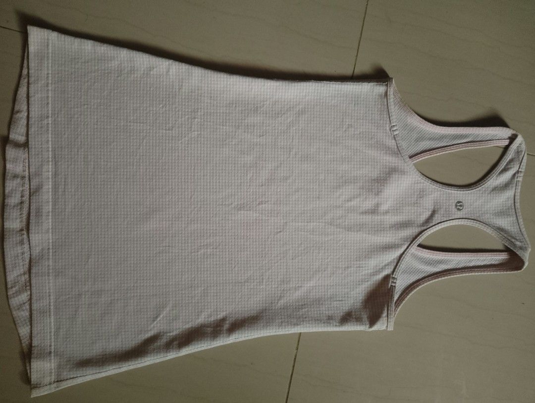 Lululemon Racerback Tank Top Light Pink (Category: Sleeveless) located in Baybay. Submitted by thriftits00 (Listing ID 1465650760, Image 2). Description: - Brand: Lululemon - Style: Racerback tank top with classic scoop neckline - Color: Light pink - Material: Breathable, textured waffle knit fabric - Details: Signature silver Lululemon logo on the upper back - Condition: Clean, excellent, and ready to wear - Ideal for: Gym workouts, yoga, runnin