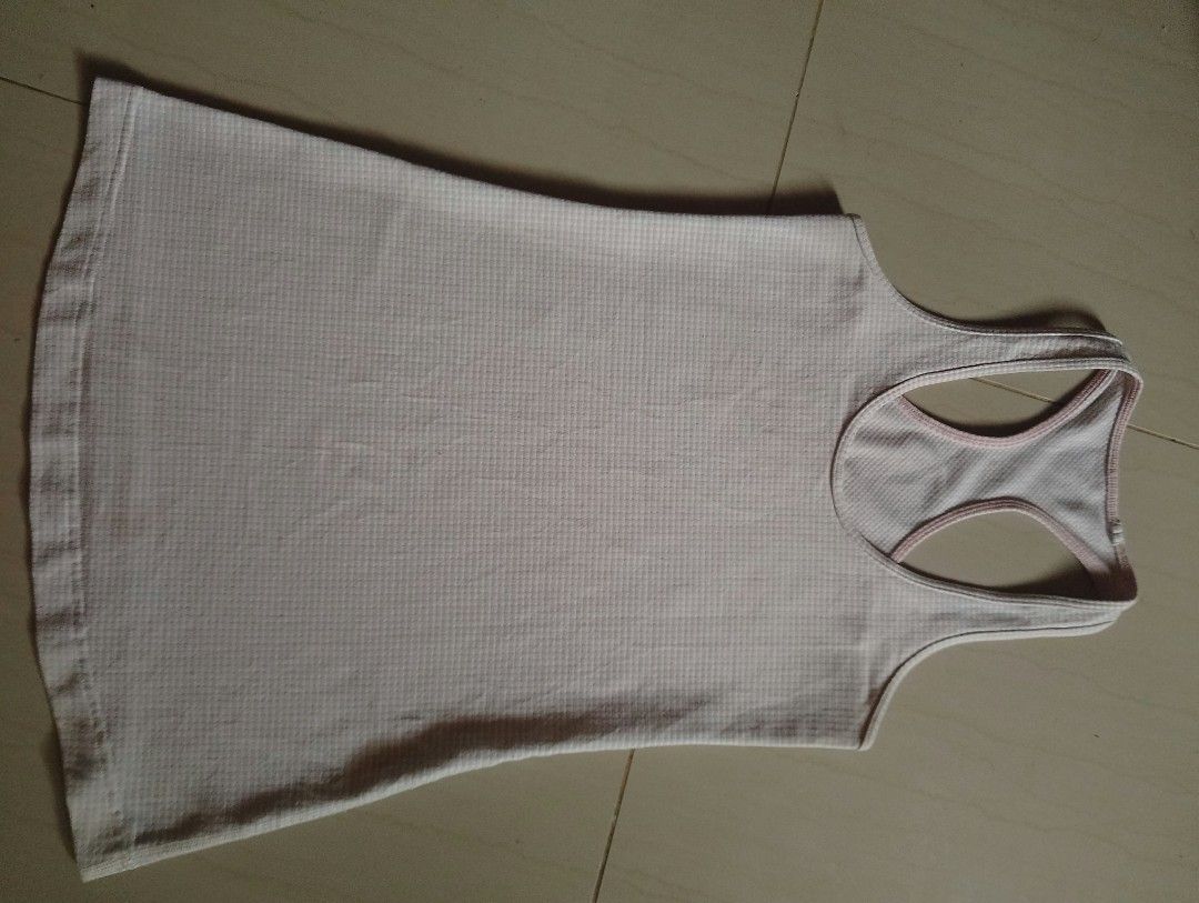 Lululemon Racerback Tank Top Light Pink (Category: Sleeveless) located in Baybay. Submitted by thriftits00 (Listing ID 1465650760, Image 1). Description: - Brand: Lululemon - Style: Racerback tank top with classic scoop neckline - Color: Light pink - Material: Breathable, textured waffle knit fabric - Details: Signature silver Lululemon logo on the upper back - Condition: Clean, excellent, and ready to wear - Ideal for: Gym workouts, yoga, runnin