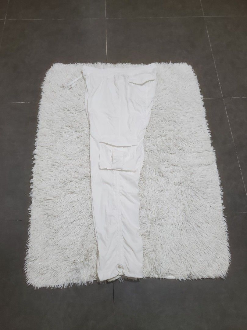 Lululemon White Cargo Pants (Category: Jeans) located in Manila. Submitted by royalrabbit.7b2a11 (Listing ID 1465715790, Image 3). Description: - Brand: Lululemon - Color: White - Fit: Relaxed fit with gathered side details - Material: Lightweight fabric, ideal for workouts or casual wear - Features: Multiple utility pockets for functionality - Adjustability: Drawstrings at the waist and hems for a customized fit.