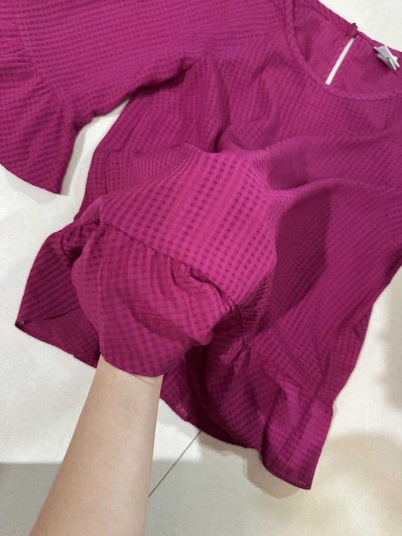 Magenta Bell Sleeve Ruffle Hem Blouse (Category: Blouses) located in Quezon City. Submitted by sweetlyluxe (Listing ID 1465620835, Image 2). Description: - Color: Magenta pink with subtle check pattern - Size: XS - Design: Bell sleeves, ruffled hem, and back keyhole button closure - Material: Lightweight and comfortable .