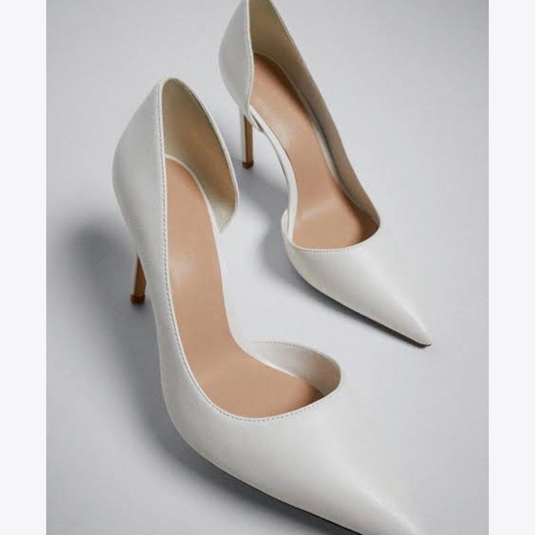 MANGO Asymmetric Stiletto Shoes White (Category: Heels) located in Davao. Submitted by oh.cake (Listing ID 1465683019, Image 2). Description: - Brand: Mango - Style: White asymmetric stiletto shoes with modern silhouette - Features: Pointed toe, slim high heel, and stylish side cutout - Sizing: Standard Mango sizing - Occasions: Ideal for parties, dinners, and formal events RFS: decluttering Price is negotiable if you're sure about taking the ite