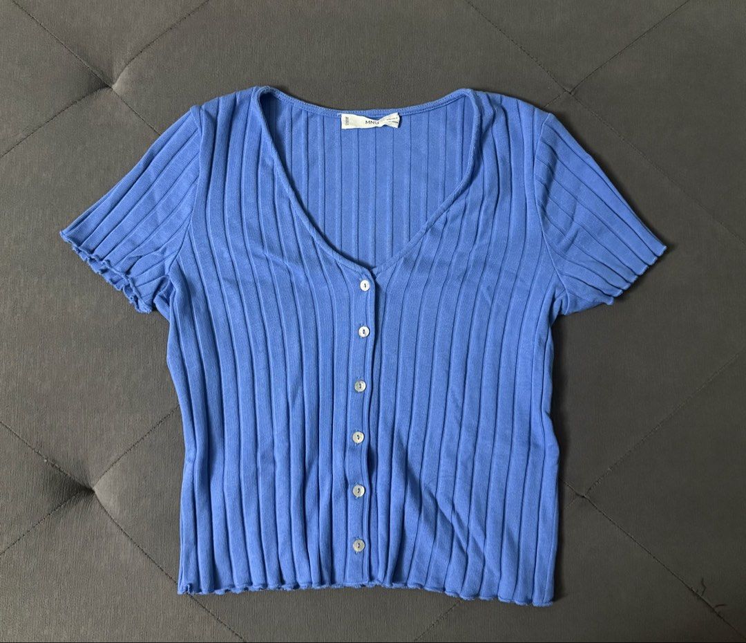 Mango Blue Ribbed Button-Down Short Sleeve Top (Category: Blouses) located in Quezon City. Submitted by misshyy_ (Listing ID 1465717068, Image 1). Description: - Brand: MNG - Color: Blue - Material: Ribbed knit fabric - Design: Short sleeves, wavy lettuce hem, V-neckline with decorative white buttons - Fit: True to size - Condition: Excellent casual piece for everyday wear.